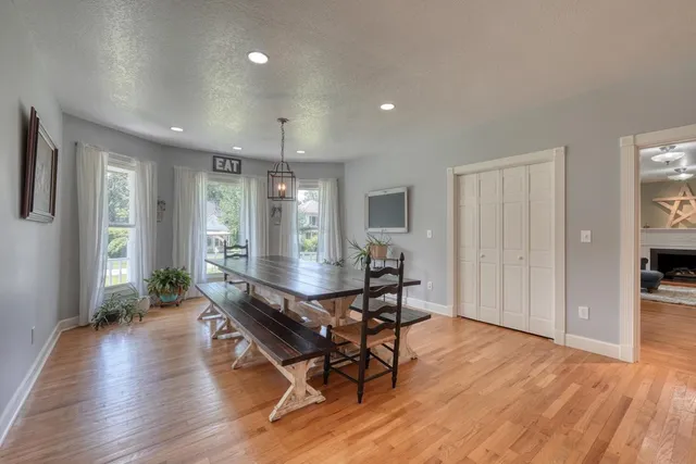 a view of a dining room with furniture and wooden floor