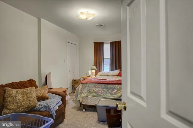 a bedroom with bed and a window