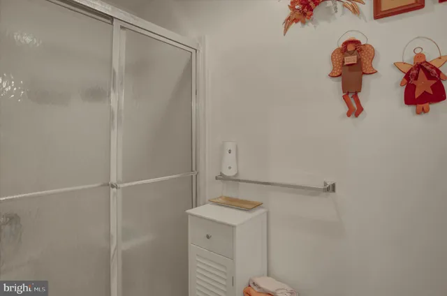 a view of swimming pool with lawn chairs and iron fence