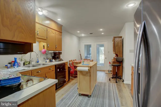 a kitchen with a sink appliances and cabinets