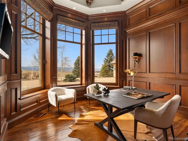 a living room with couches and a large with kitchen view