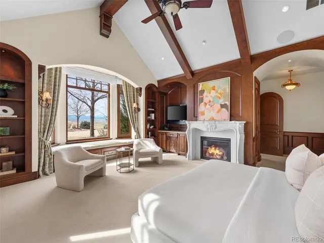 a living room with furniture a fireplace and a chandelier