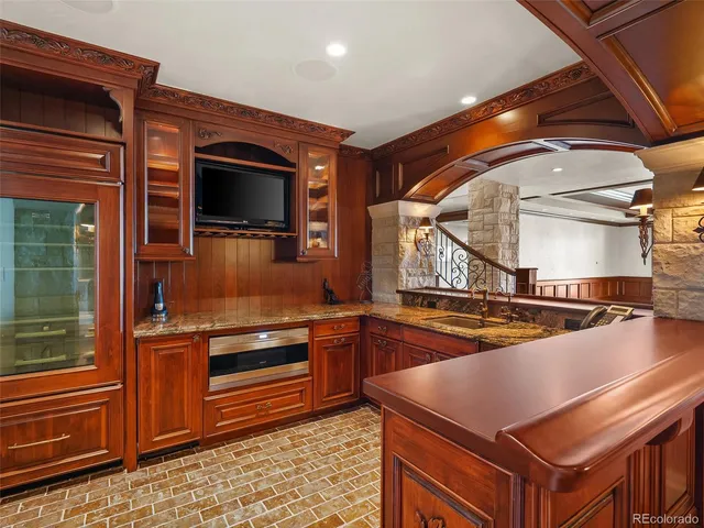 a living room with furniture a fireplace and a floor to ceiling window