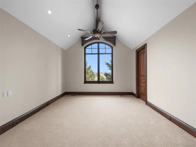 a view of balcony with chairs and wooden fence
