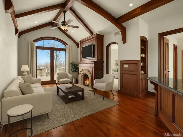 a view of a patio with table and chairs with wooden fence and plants