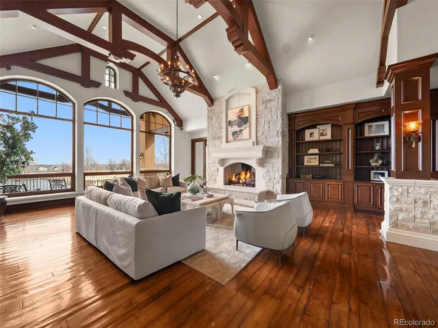 a living room with fireplace furniture and a large window