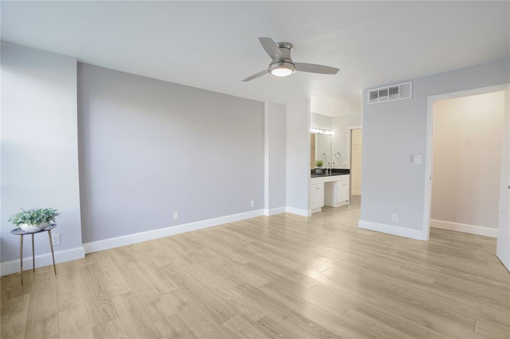 7 Royal Palm Way, Unit 304 Boca Raton, FL 33432 - Photo 12 of 30 a view of an empty room with wooden floor and a kitchen