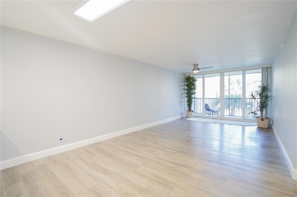 7 Royal Palm Way, Unit 304 Boca Raton, FL 33432 - Photo 7 of 30 a view of empty room with wooden floor and fireplace