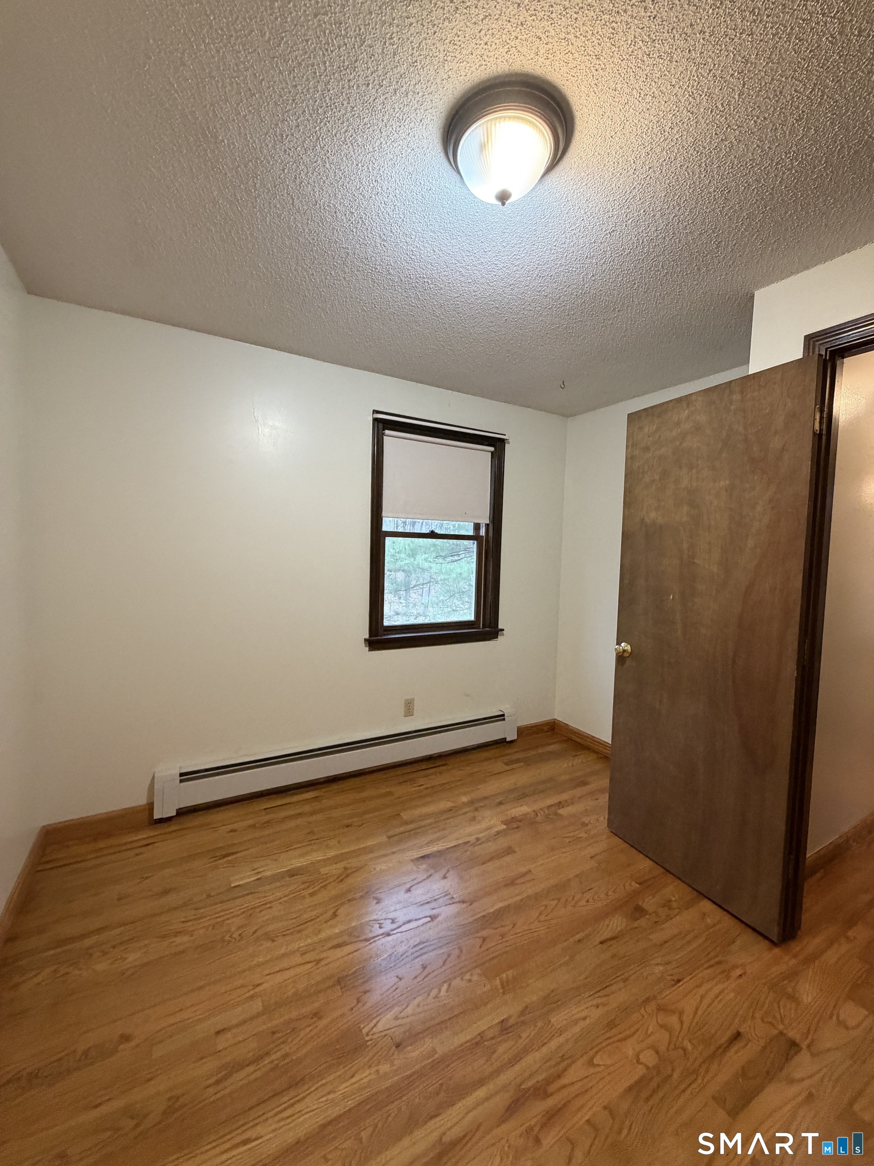 8 Brook Lane, Unit 2 Guilford, CT 06437 - Photo 12 of 12 an empty room with wooden floor and windows