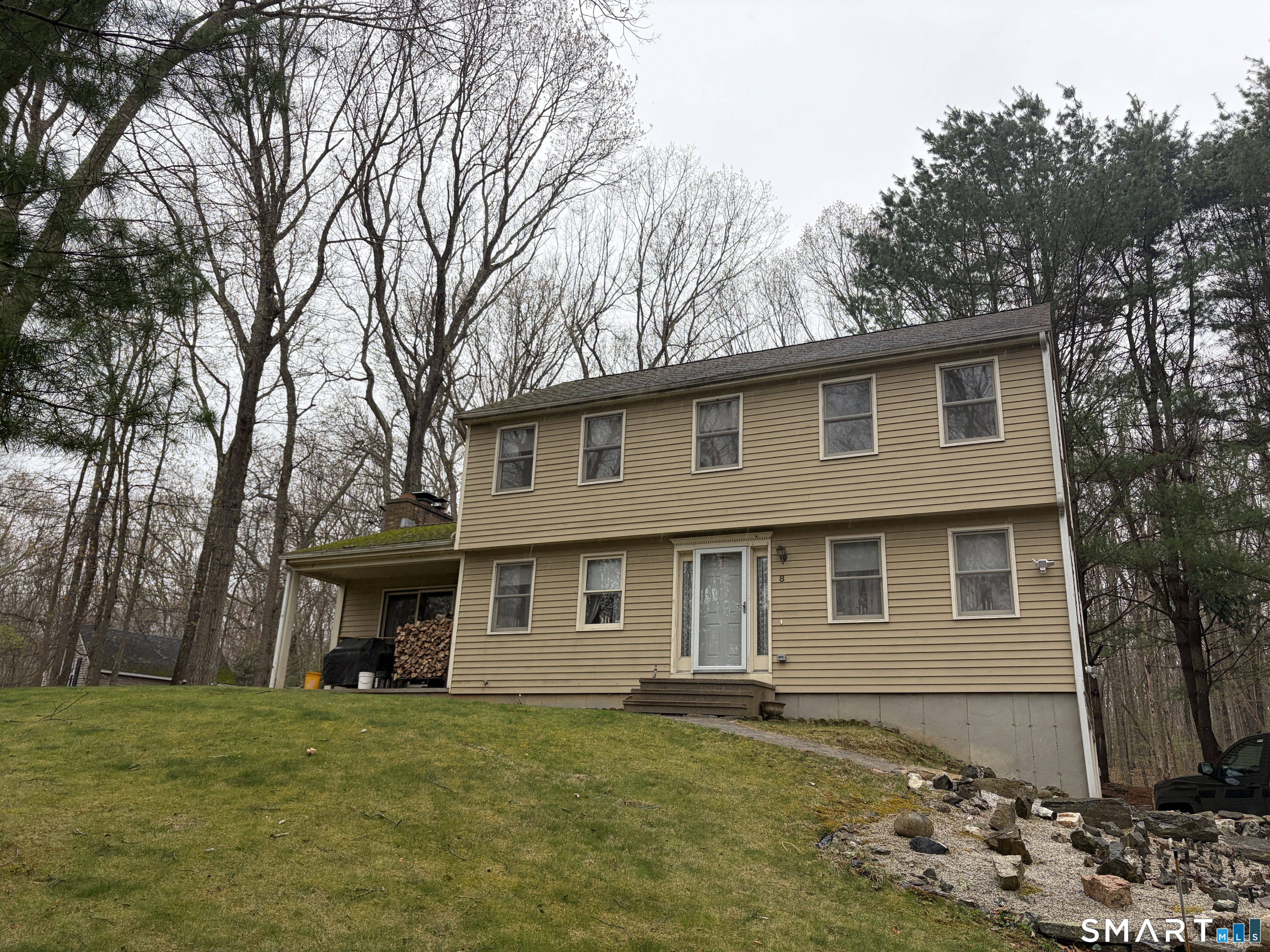 8 Brook Lane, Unit 2 Guilford, CT 06437 - Photo 2 of 12 a front view of a house with a garden