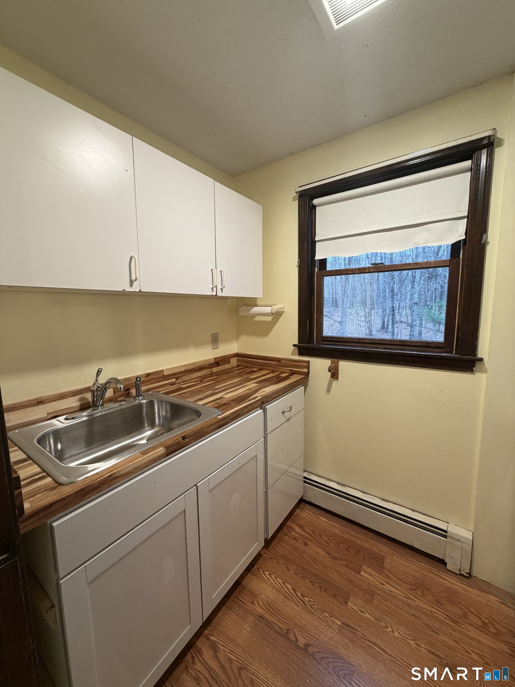 8 Brook Lane, Unit 2 Guilford, CT 06437 - Photo 4 of 12 a kitchen with a sink cabinets and a wooden floor