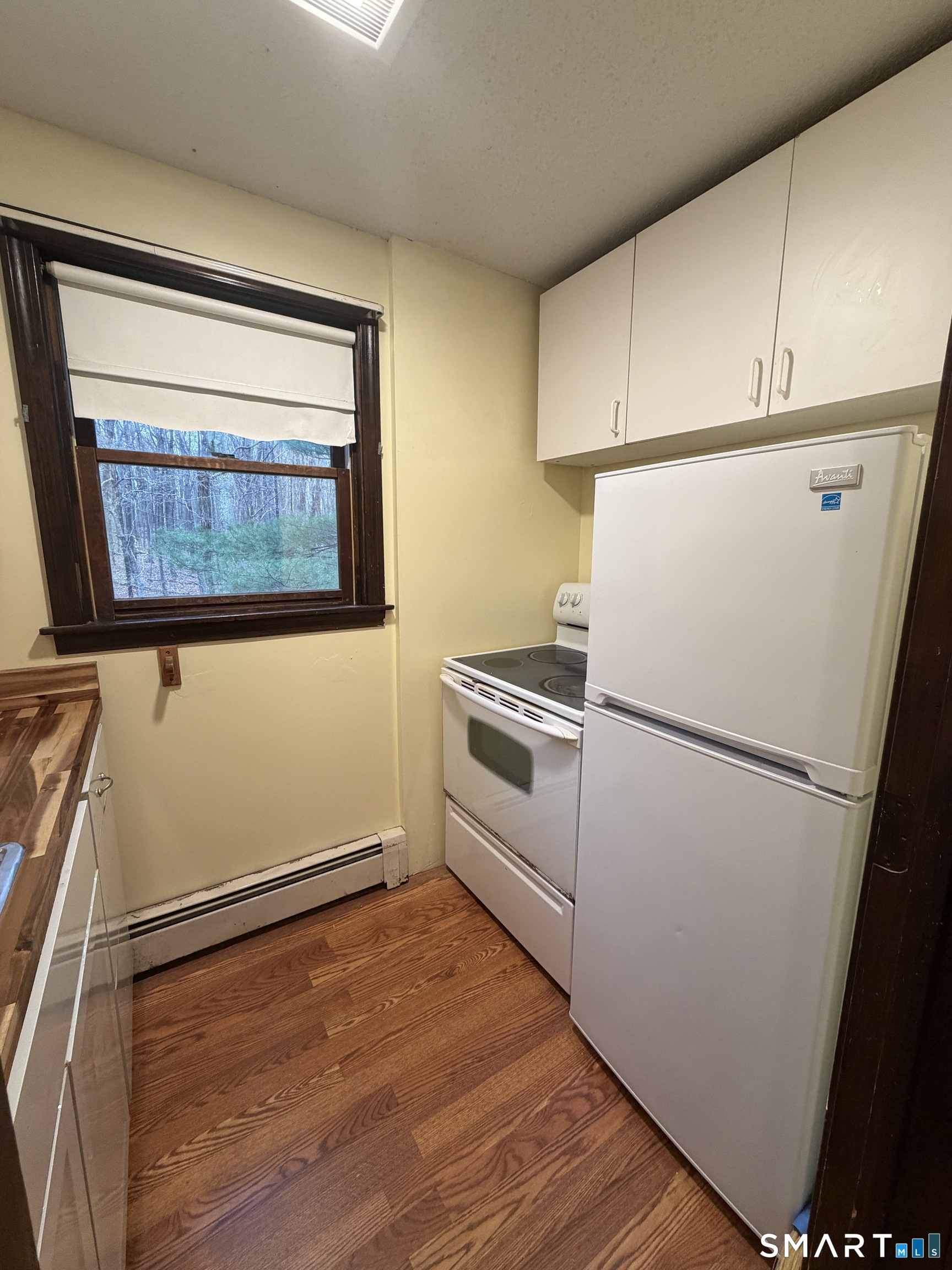 8 Brook Lane, Unit 2 Guilford, CT 06437 - Photo 5 of 12 a white refrigerator freezer and a stove sitting inside of a kitchen