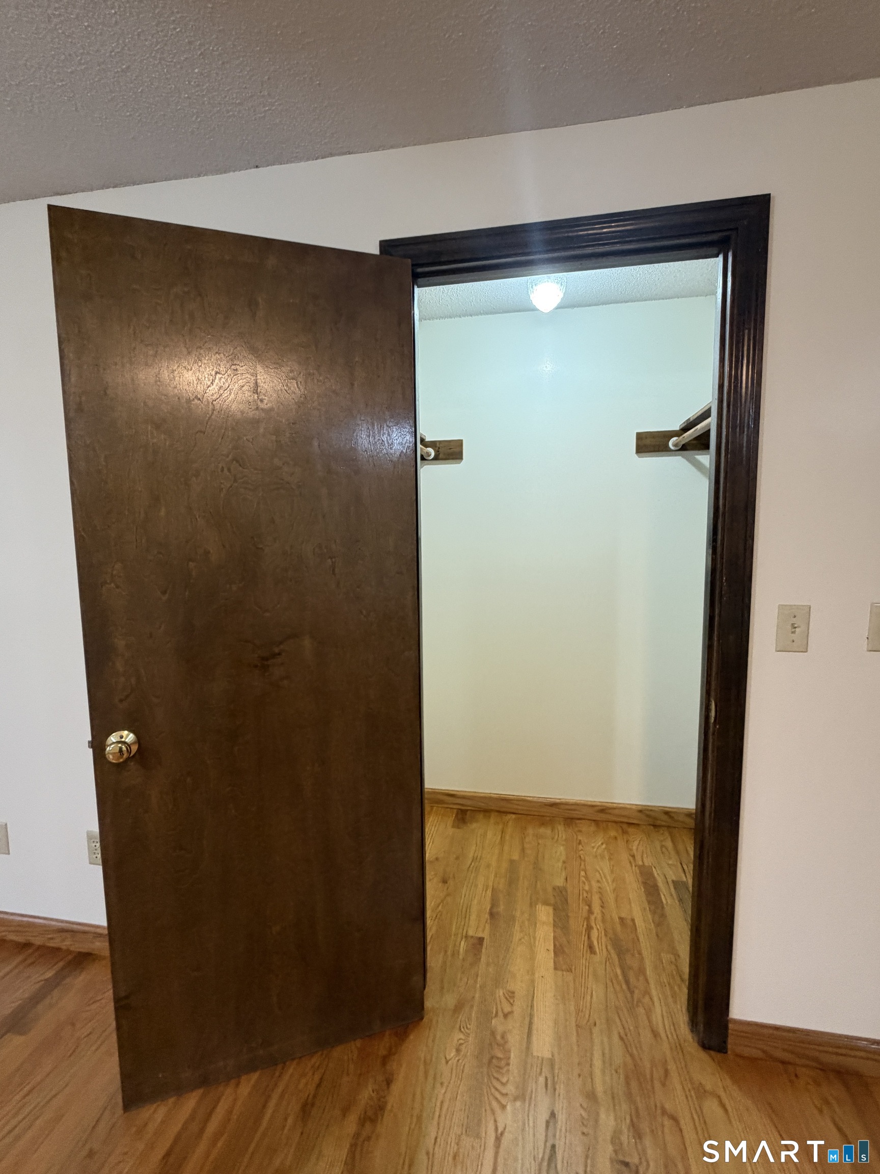 8 Brook Lane, Unit 2 Guilford, CT 06437 - Photo 9 of 12 a view of empty room with wooden floor