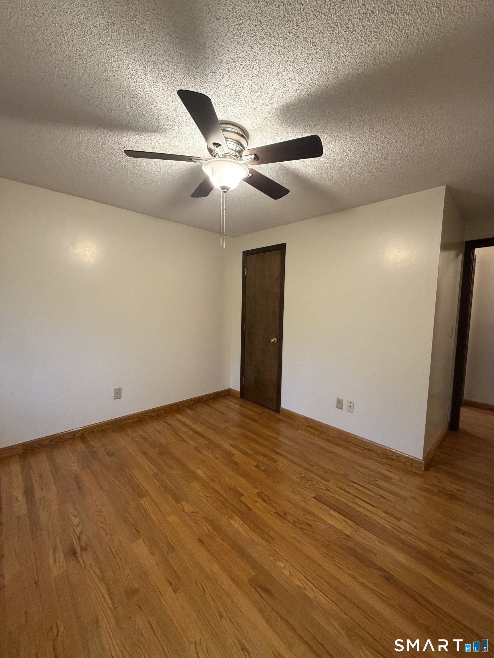 8 Brook Lane, Unit 2 Guilford, CT 06437 - Photo 10 of 12 a view of an empty room and wooden floor