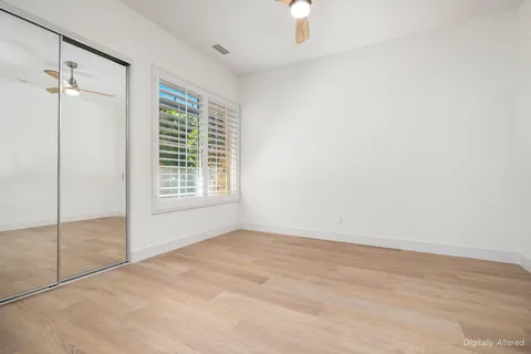 a view of a kitchen with an entryway and wooden floor