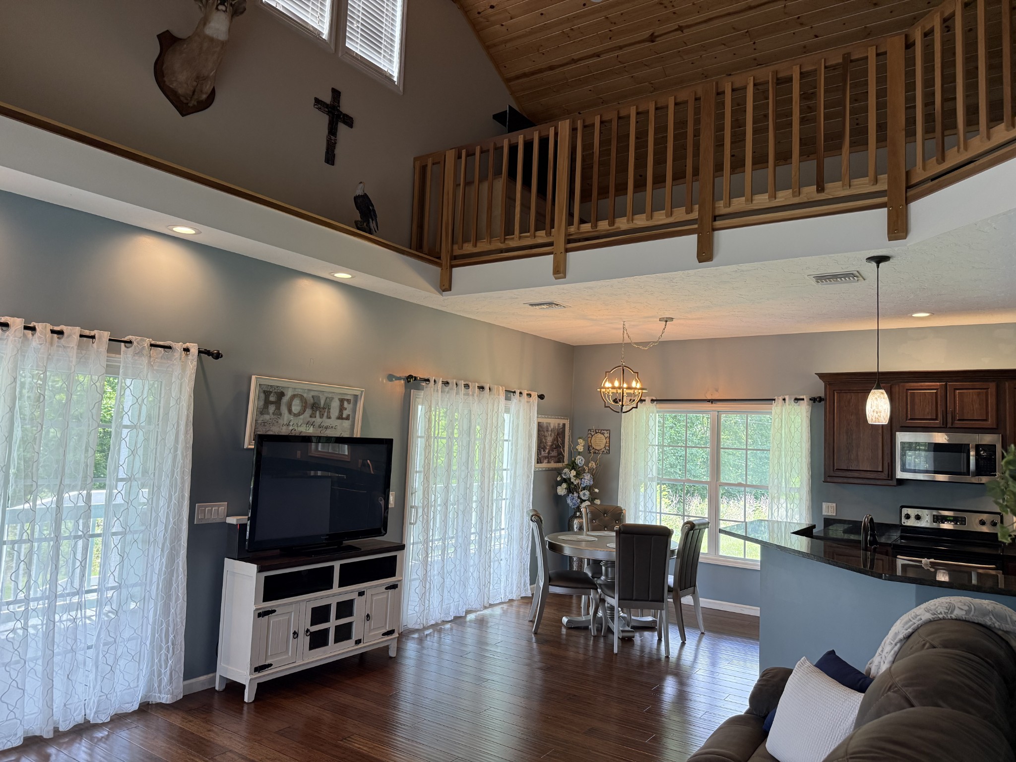 581 Shady Grove Road Bloomington Springs, TN 38545 - Photo 5 of 42 a living room with furniture a flat screen tv and wooden floor