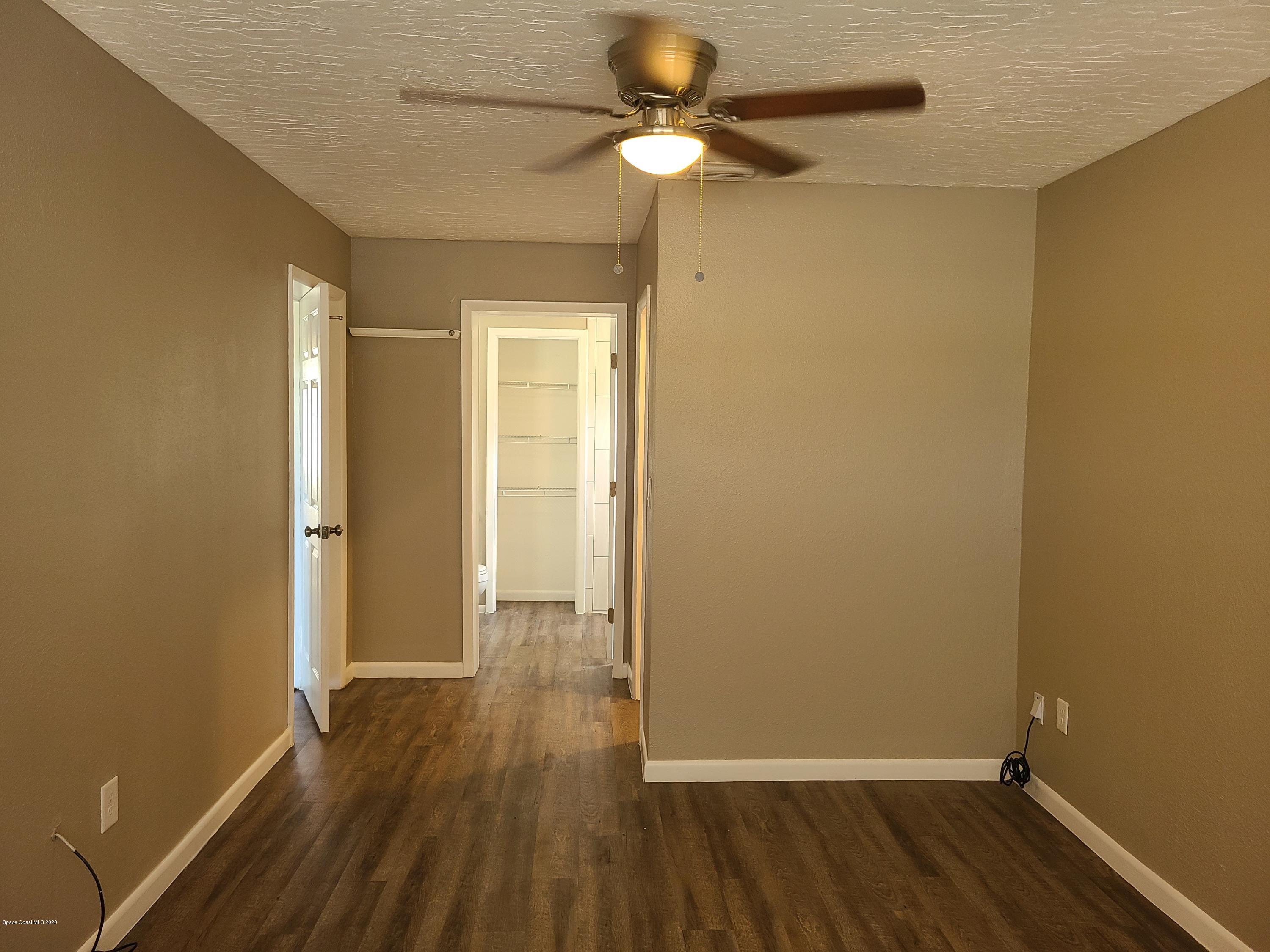 1705 Sarno (access) Road Melbourne, FL 32935 - Photo 19 of 32 wooden floor in an empty room