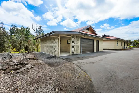 a view of a house with a backyard