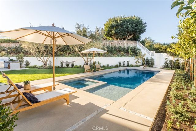 a front view of a house with swimming pool having outdoor seating