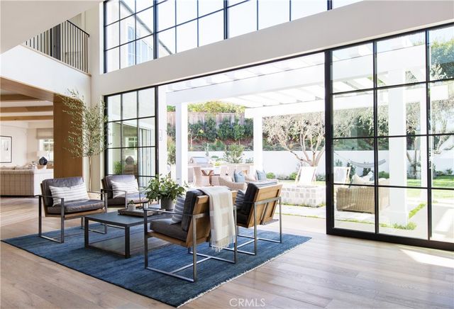 a living room with furniture a wooden floor and a large window