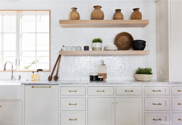 a kitchen with cabinets and window