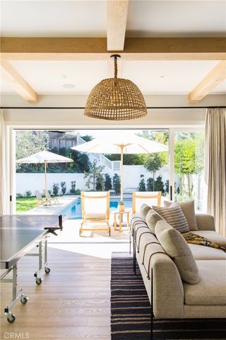 a living room with a table and a floor to ceiling window