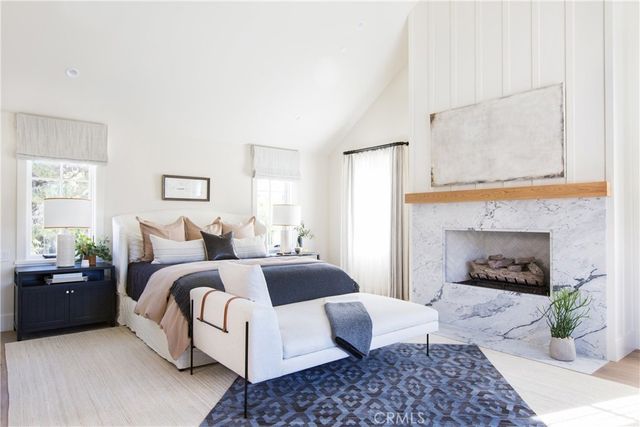 a bedroom with a bed and a fireplace