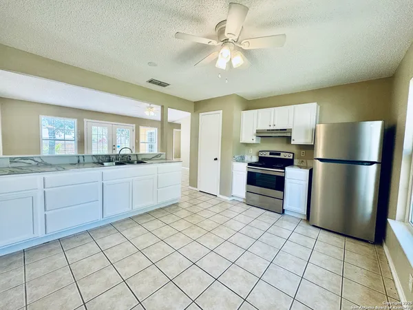a kitchen with cabinets and stainless steel appliances