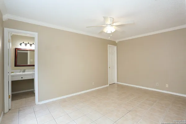 a view of a livingroom with a chandelier fan and windows