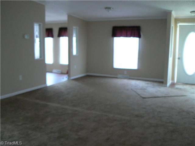 Living Room. Taken from near the fireplace, it is evident the Living Room square footage space between the front doorand the kitchen could be considered the Formal Dining Room, if so desired.