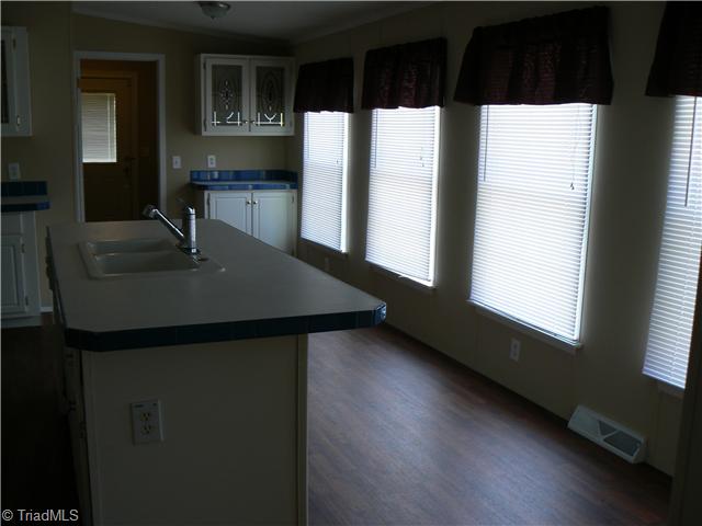 4987 King View Road Asheboro, NC 27205 - Photo 9 of 16 Kitchen. Here you see the source of all the natural light; four long windows. Sorry picture is bit dark. Note: extra storage cabinets/work area beyond the two main counter areas. The spacious pantry is 4 x 5 7"!