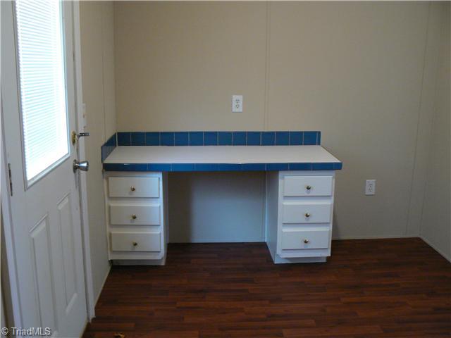 4987 King View Road Asheboro, NC 27205 - Photo 10 of 16 Laundry Room. This laundry, of which only half is shown here, is approx. 8 x13 with exterior door leading out to the deck. How about this handy desk for the computer or for use as a folding table?