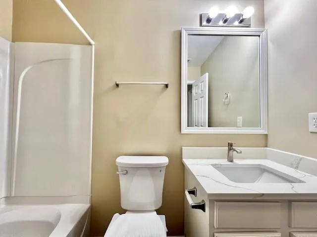 a bathroom with a sink toilet and vanity