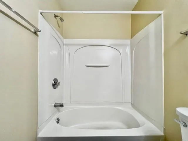 a bathroom with a tub and shower
