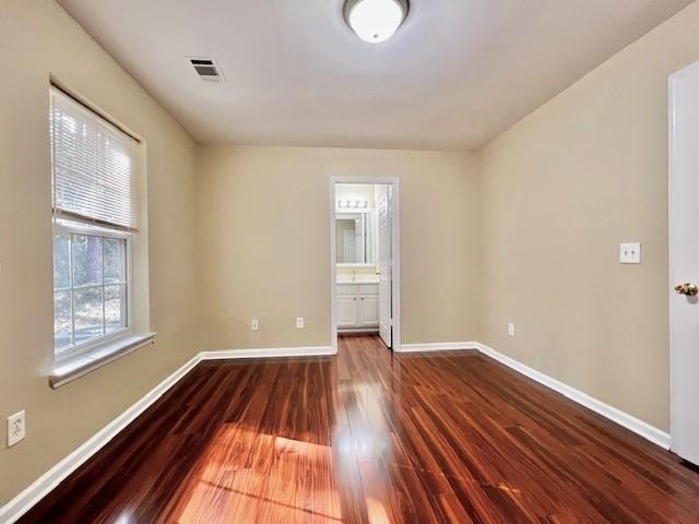 2459 Ivey Crest Circle Tucker, GA 30084 - Photo 3 of 18 a view of an empty room with wooden floor and a window