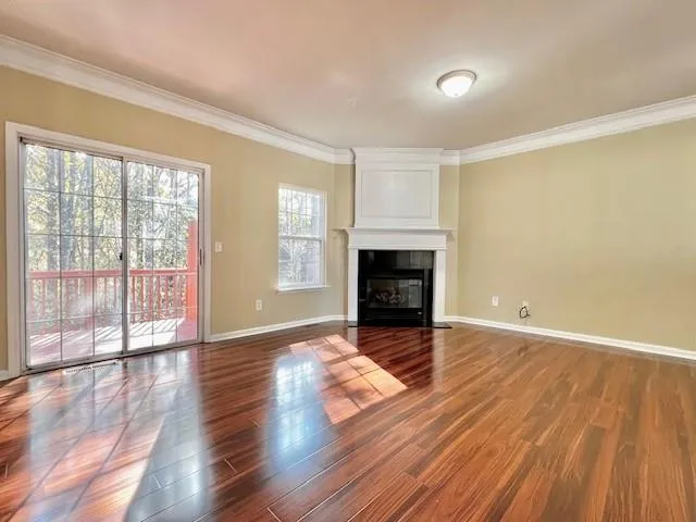 wooden floor fireplace and natural light in room