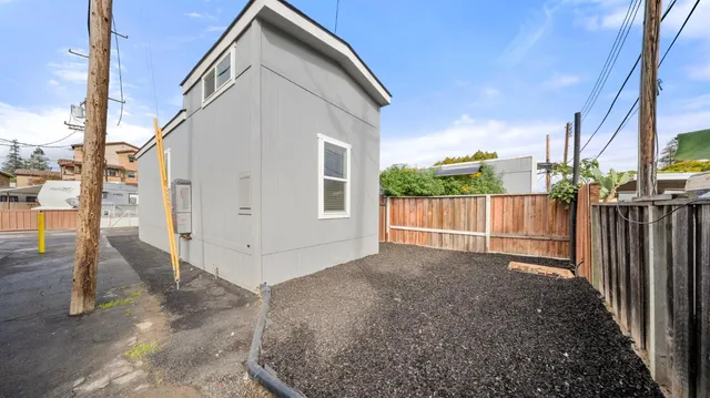 a view of a house with a small yard