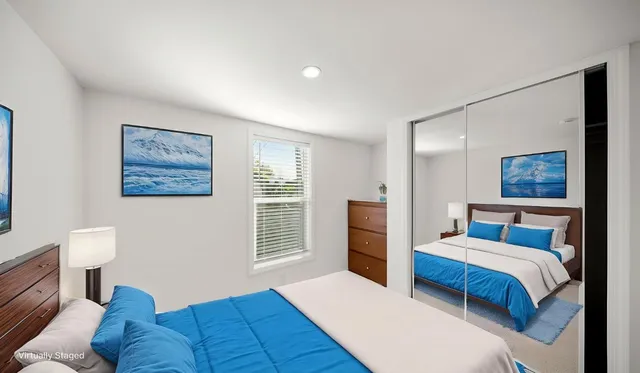 a bedroom with a large bed and a couch