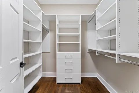 a bedroom with a bed table and a window