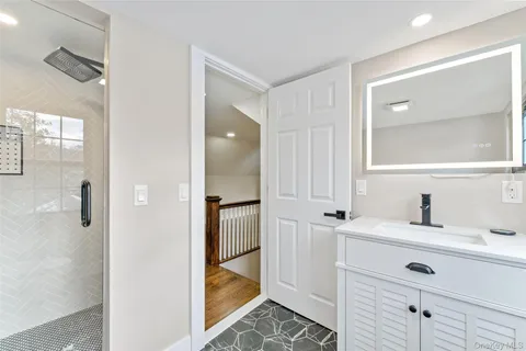 a bathroom with a toilet sink and mirror