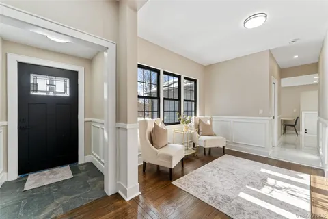 a living room with furniture fireplace and window