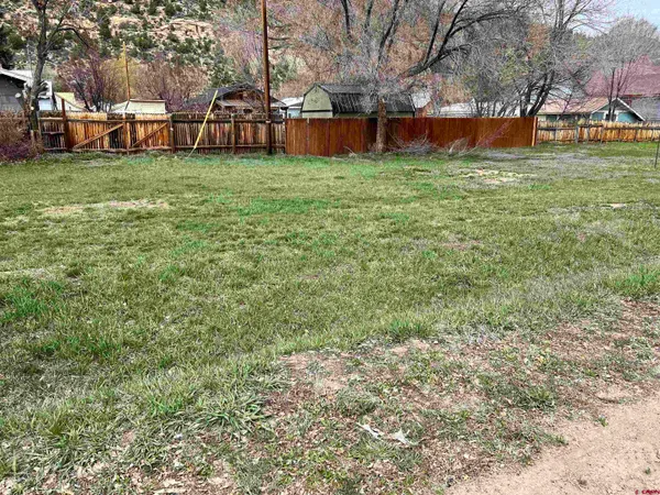 a view of backyard with table and chairs