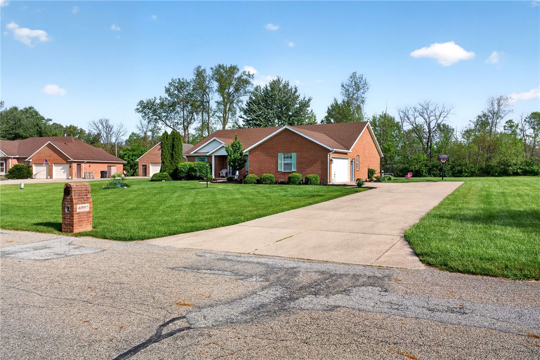4996 Shannon Avenue Springfield, OH 45504 - Photo 46 of 61 This classic brick residence boasts a neatly manicured lawn and an inviting driveway, offering ample parking.