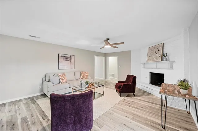 a living room with furniture a fireplace and a table