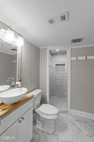 a bathroom with a toilet a sink and shower