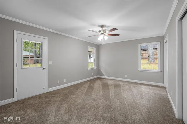 a view of room with window and ceiling fan