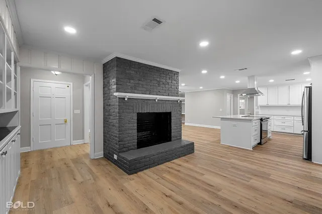 a view of kitchen and kitchen with granite countertop wooden floor