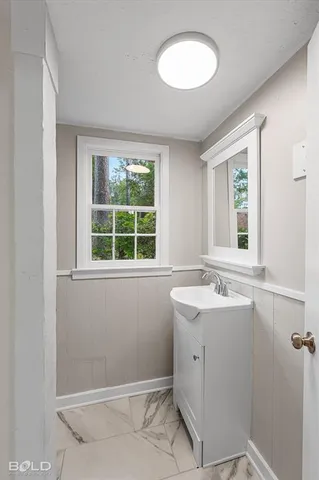 an aerial view of residential house with outdoor space and trees all around