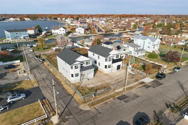 an aerial view of residential houses with city view