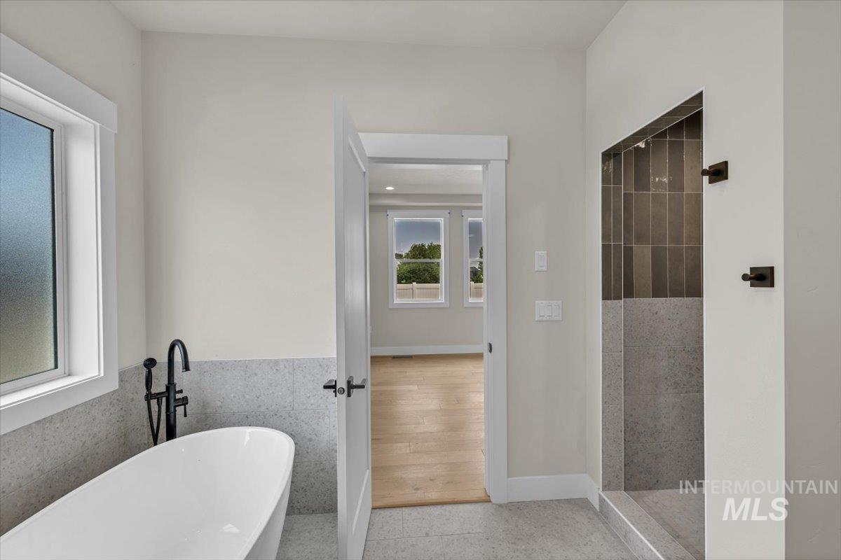 72 South Ravine Way Nampa, ID 83687 - Photo 26 of 48 Neutral wall paint, gray carpeting, and a ceiling fan with integrated lighting